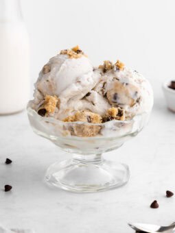 vegan cookie dough ice cream scoops inside a sundae glass