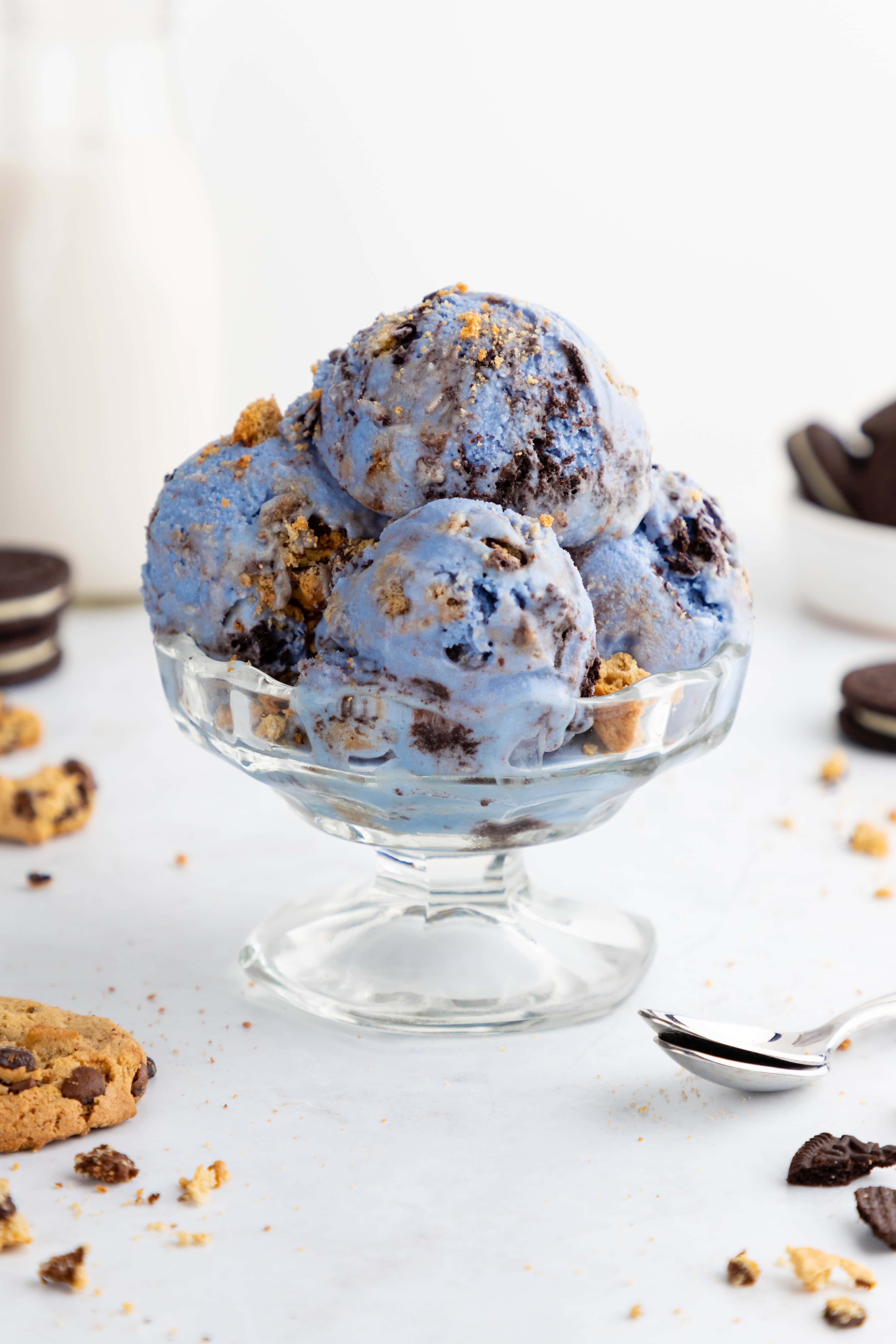 a glass bowl filled with scoops of homemade vegan cookie monster ice cream