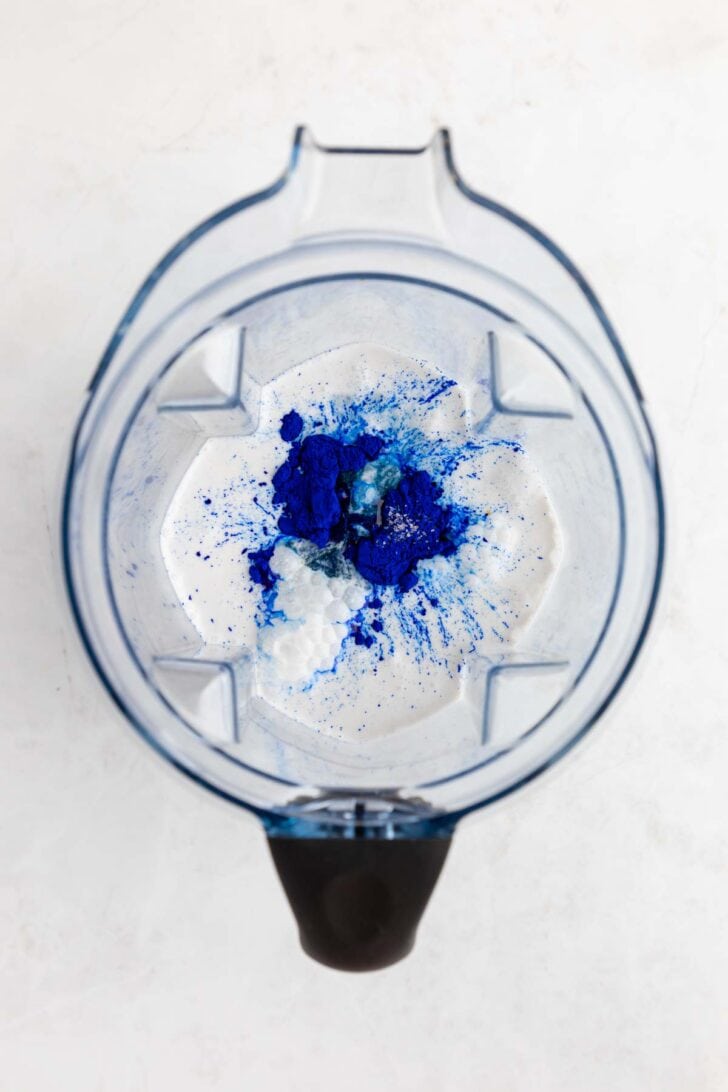 coconut milk, sugar, and blue spirulina inside a vitamix blender